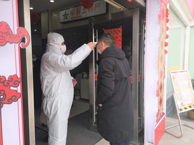 釜山服務(wù)區阮忠斌正在給旅客測量體溫.jpg